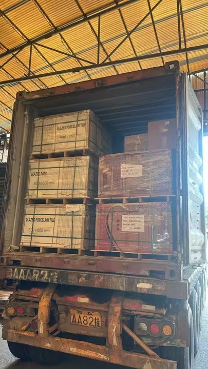 Overseas shipping container being loaded with weight-balanced pallets for quality assurance.