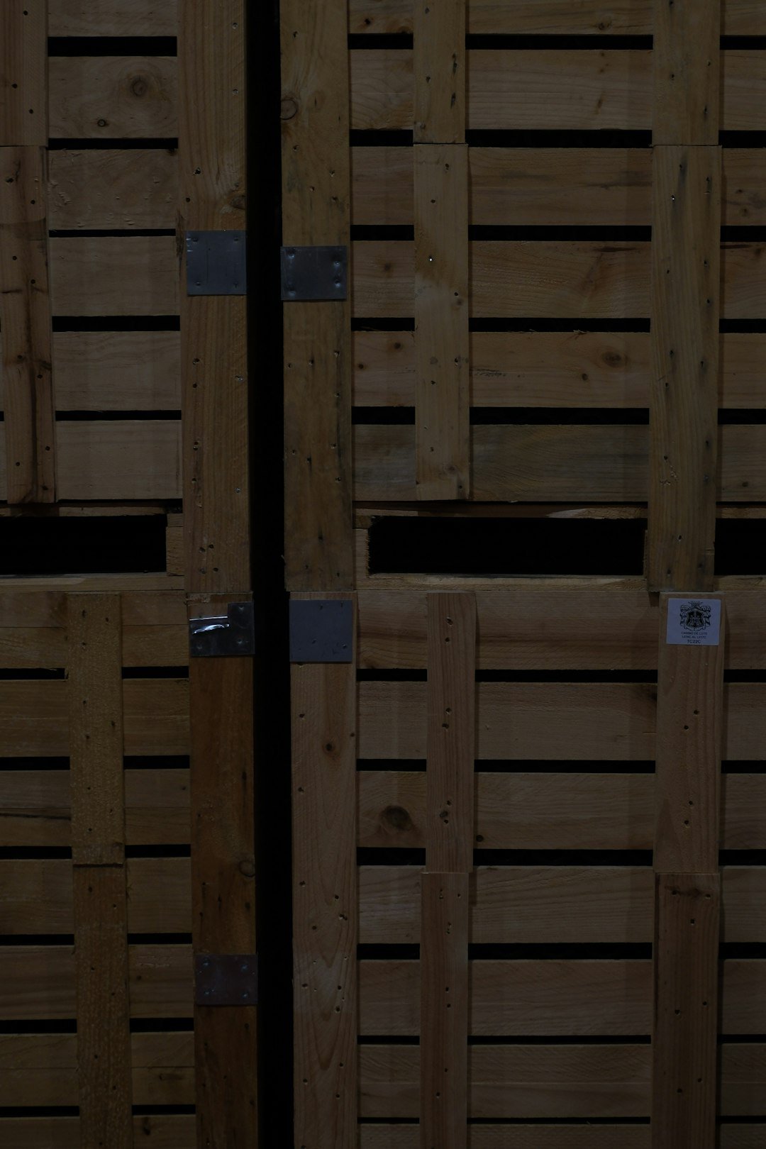 Stacked wooden export crates with metal clasps ready for sea freight